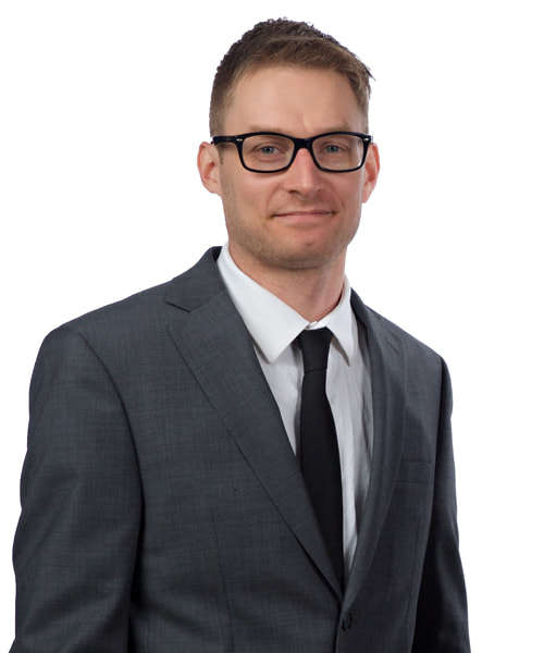 Professional headshot of a young blonde male wearing a suit. This is Michael Daugherty, a Content & SEO Specialist at Borealis Digital Marketing